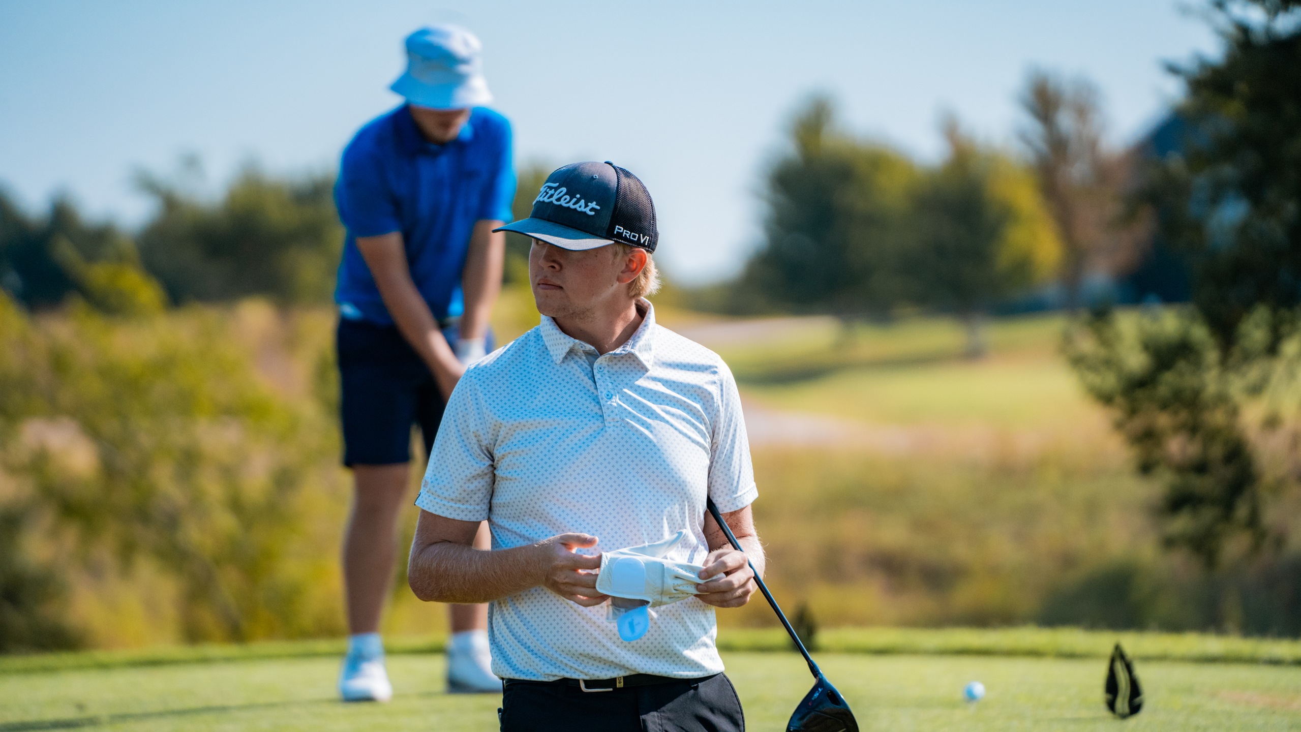 Jaxen Brewer removes his glove as he leaves the tee-box